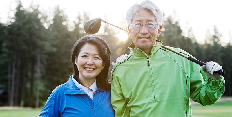 Senior couple playing golf